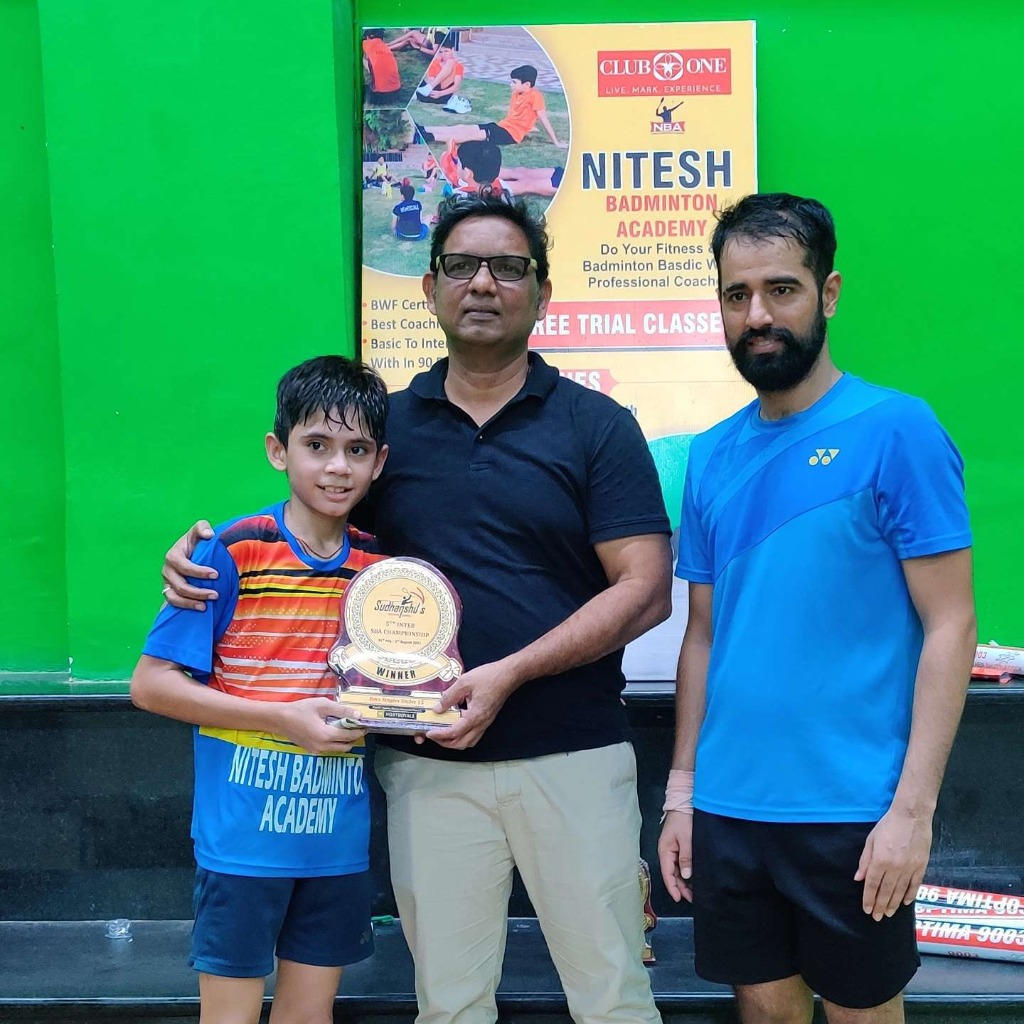 Coach Nitesh celebrating tournament championship winner with academy player